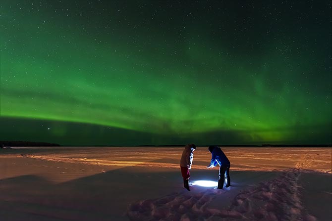 two people under the northern lights