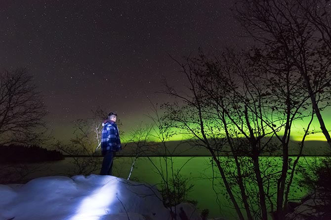 a kid under the northern lights